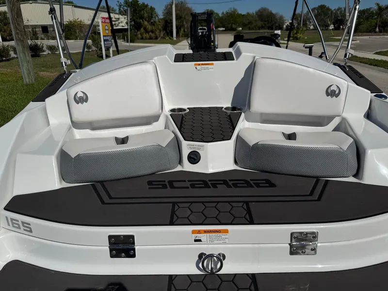 Slide: The Image of 2022 Scarab 165 ID boat interior with seating and storage compartments. - 32