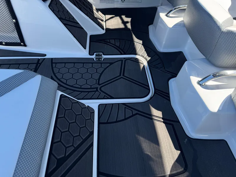 Slide: The Image of 2022 Scarab 165 ID boat interior with hexagonal patterned flooring and seating. - 34