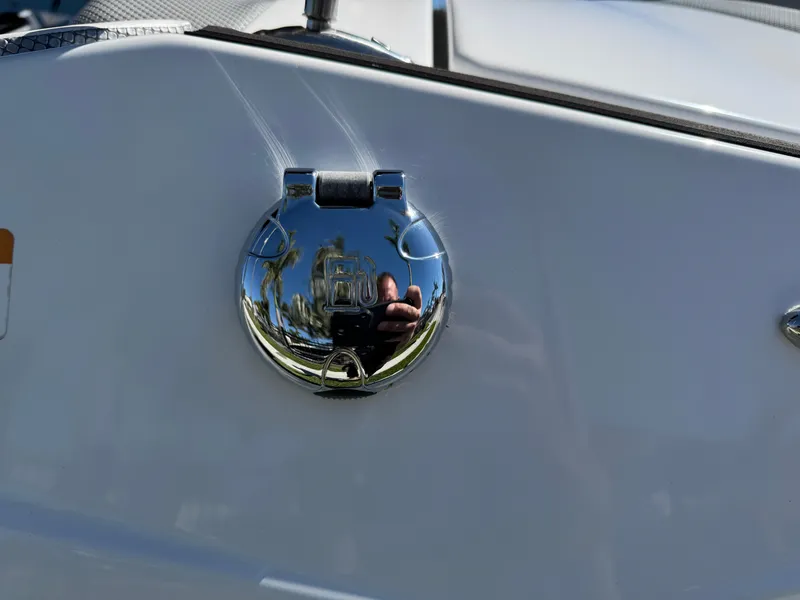 Slide: The Image of Chrome fuel cap on 2022 Scarab 165 ID boat, reflecting surroundings. - 8