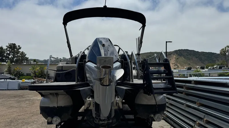 Slide: The Image of 2023 Barletta Lusso 23UC pontoon boat, rear view, parked outdoors. - 11