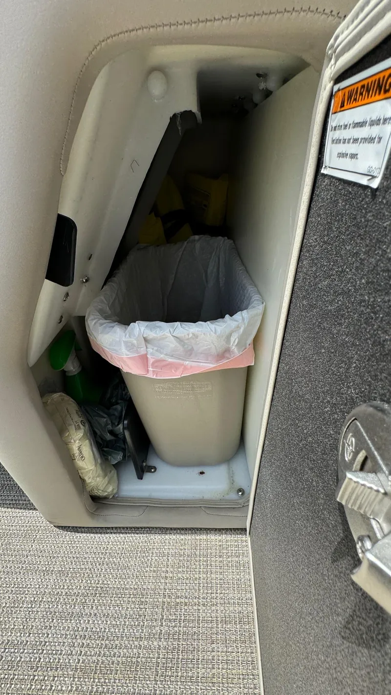 Slide: The Image of Trash bin inside 2023 Barletta Lusso 23UC storage compartment. - 24