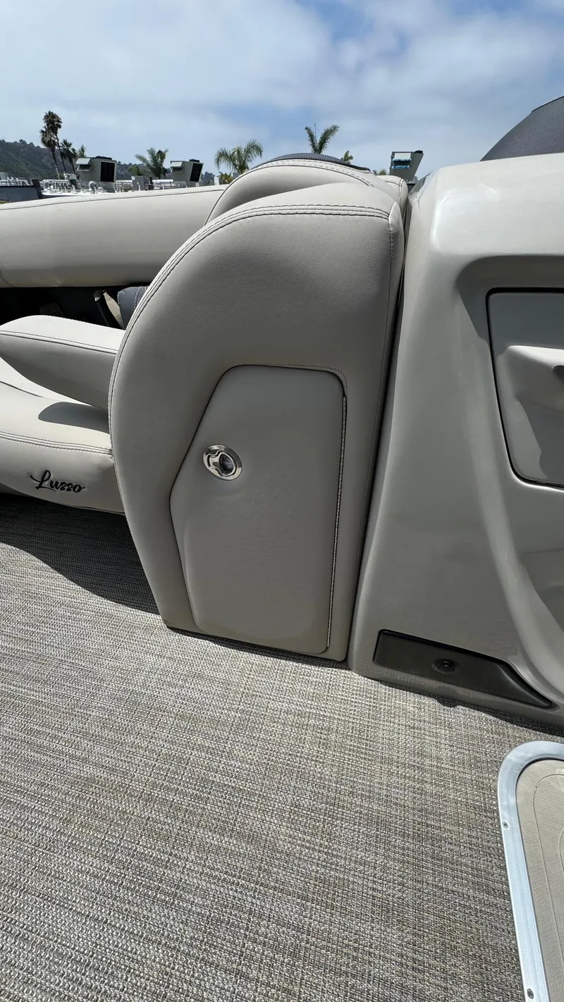 Slide: The Image of 2023 Barletta Lusso 23UC interior with beige upholstery and storage compartment. - 25