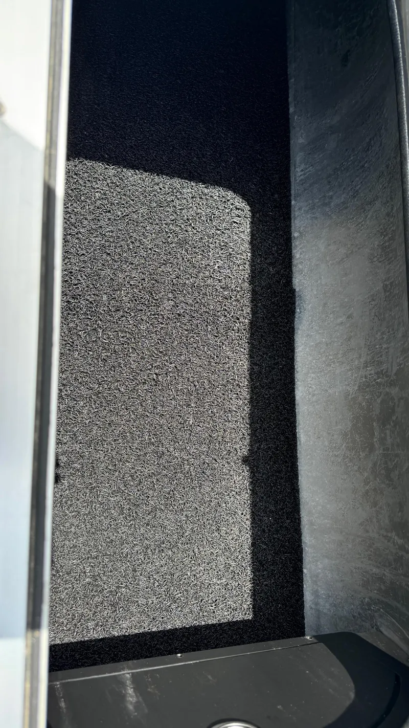 Slide: The Image of 2023 Barletta Lusso 23UC storage compartment with black interior lining. - 26