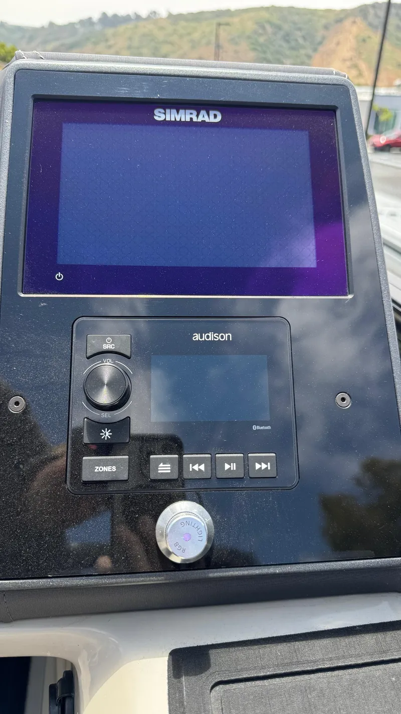 Slide: The Image of 2023 Barletta Lusso 23UC dashboard with Simrad display and Audison controls. - 32