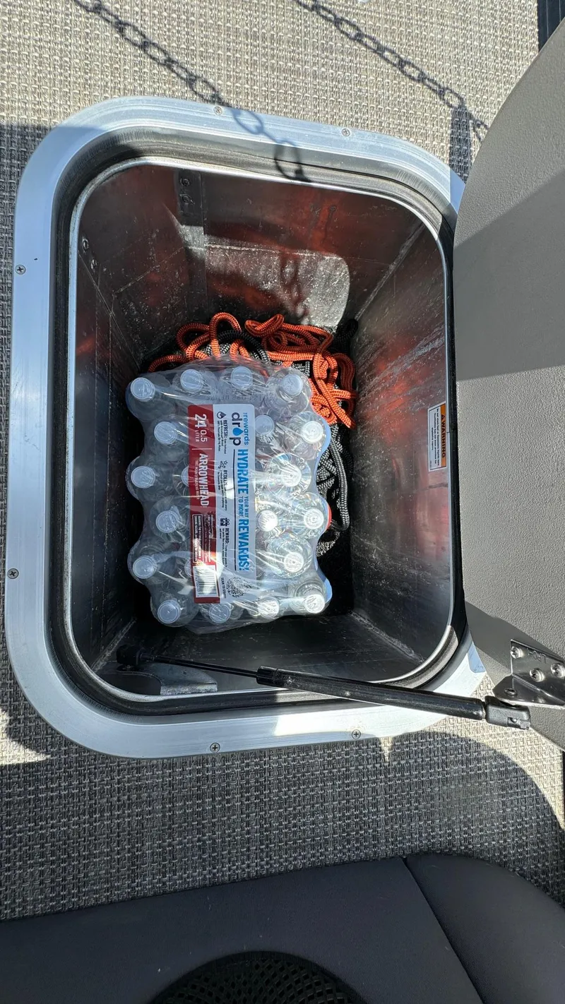 Slide: The Image of Storage compartment in 2023 Barletta Lusso 23UC with bottled water and orange rope. - 37