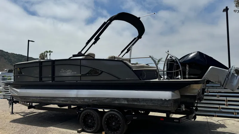 Slide: The Image of 2023 Barletta Lusso 23UC pontoon boat on trailer, side view, outdoors. - 6