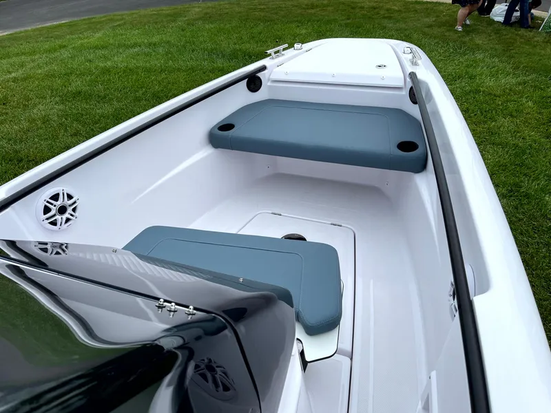 Slide: The Image of 2024 Axopar 22 boat interior with seating and sleek design on grass. - 10