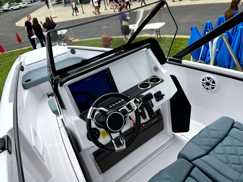 Slide: The Image of 2024 Axopar 22 boat cockpit with modern steering and controls. - 12