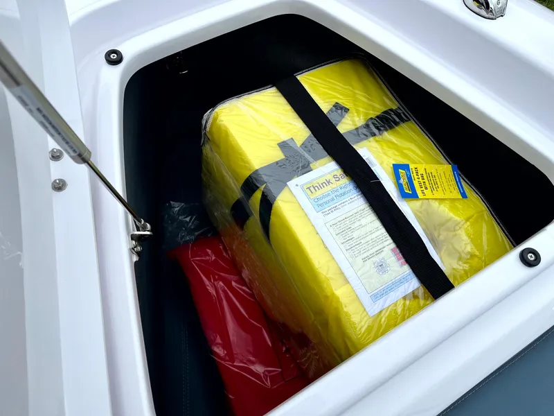 Slide: The Image of Storage compartment of 2024 Axopar 22 boat with safety equipment. - 13