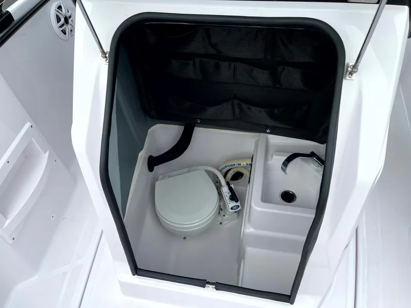 Slide: The Image of 2024 Axopar 22 boat interior with compact toilet and sink. - 14