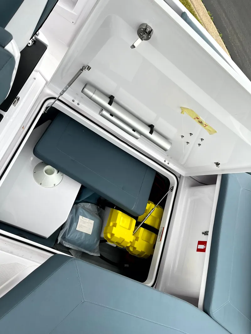 Slide: The Image of 2024 Axopar 22 storage compartment with seating and safety equipment. - 19