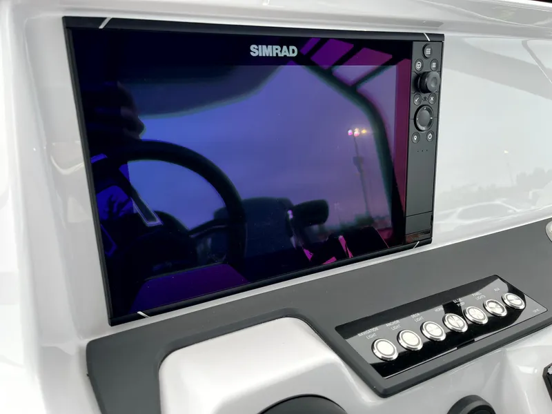 Slide: The Image of 2024 Axopar 22 boat dashboard featuring Simrad display and control panel. - 20