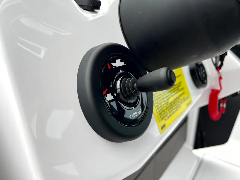 Slide: The Image of Close-up of 2024 Axopar 22 boat control panel with trim tab switch. - 21