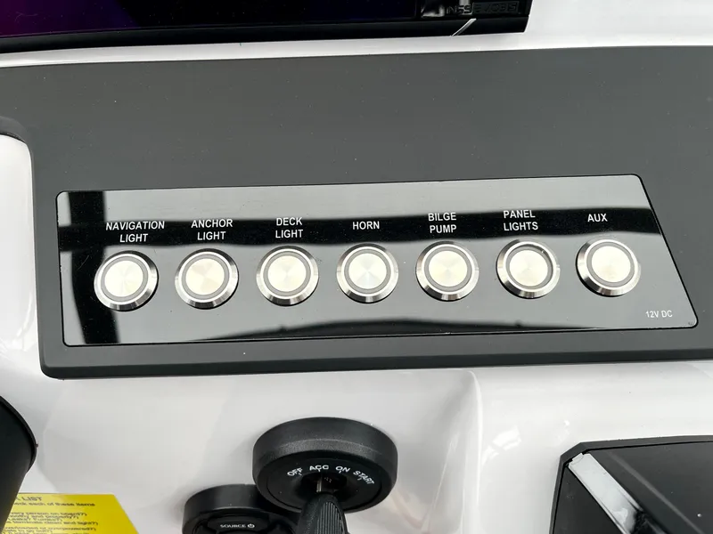 Slide: The Image of Control panel of 2024 Axopar 22 boat with labeled switches for various functions. - 22