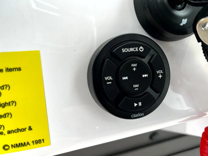 Slide: The Image of Control panel of a 2024 Axopar 22 boat featuring a Clarion audio system. - 23