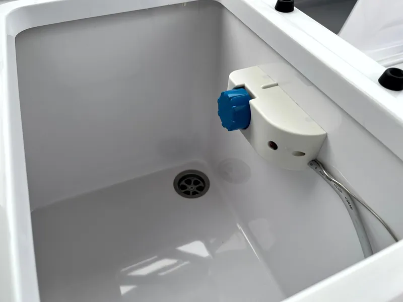 Slide: The Image of 2024 Axopar 22 boat sink with drain and faucet. - 26