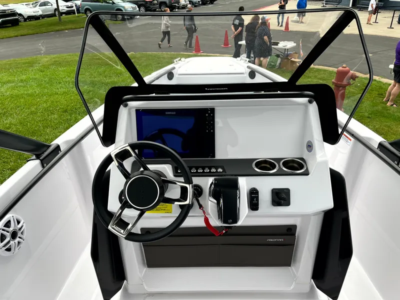 Slide: The Image of 2024 Axopar 22 boat dashboard with steering wheel, touchscreen, and controls. - 4