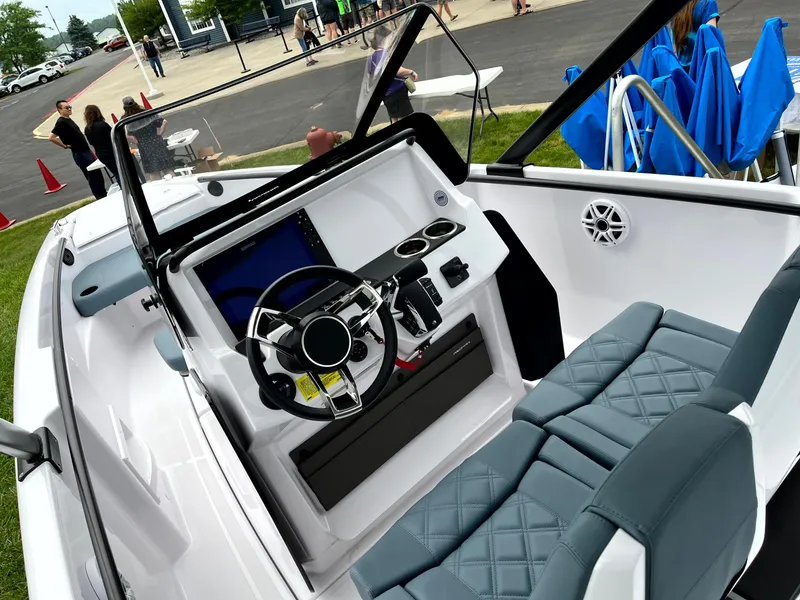 Slide: The Image of 2024 Axopar 22 boat interior with modern dashboard and seating. - 5