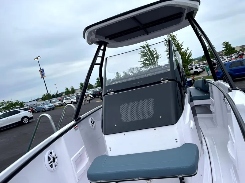 Slide: The Image of 2024 Axopar 22 boat with sleek design, featuring a modern console and seating, parked outdoors. - 6