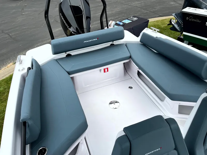 Slide: The Image of 2024 Axopar 22 boat interior with blue seating and modern design. - 7