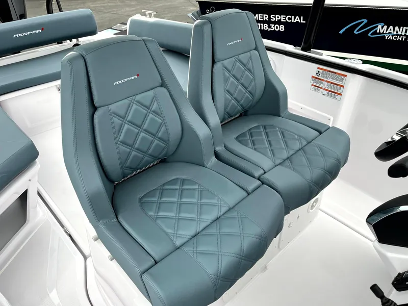 Slide: The Image of 2024 Axopar 22 boat interior with stylish, quilted blue seats. - 8