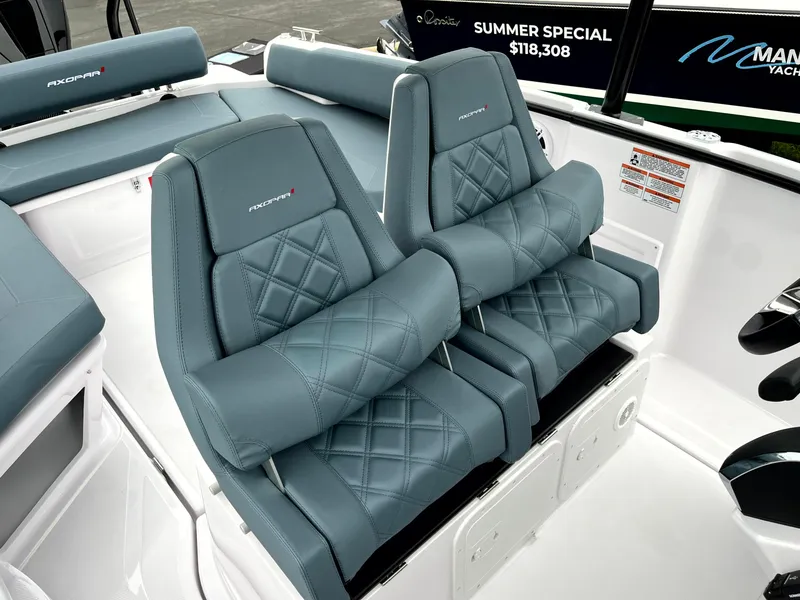 Slide: The Image of 2024 Axopar 22 boat interior with luxurious blue quilted seats. - 9