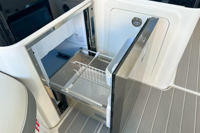 Slide: The Image of 2025 Sea Ray Sundancer 370 boat interior with open refrigerator drawer. - 13