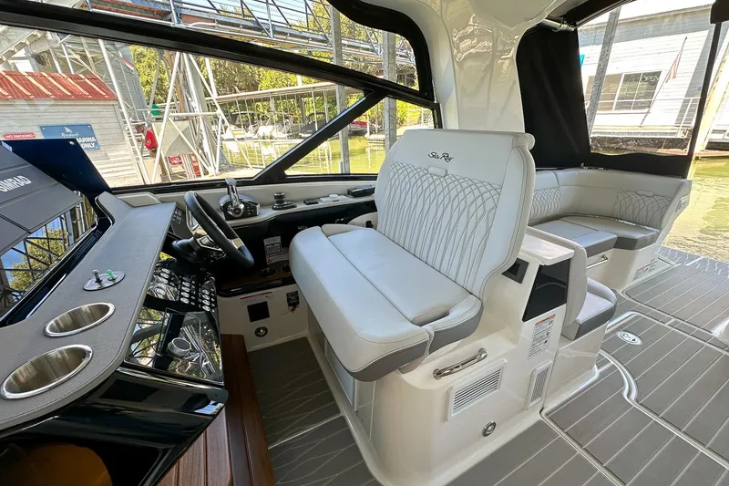Slide: The Image of 2025 Sea Ray Sundancer 370 cockpit with luxurious seating and modern controls. - 14
