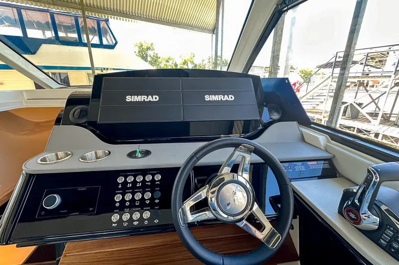 Slide: The Image of 2025 Sea Ray Sundancer 370 helm with Simrad navigation system and modern controls. - 17