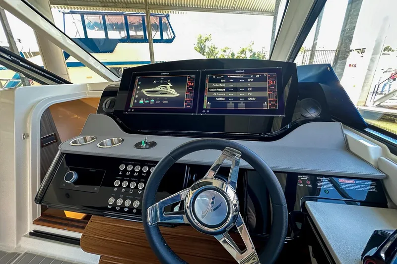 Slide: The Image of 2025 Sea Ray Sundancer 370 helm with advanced navigation display and sleek steering wheel. - 18