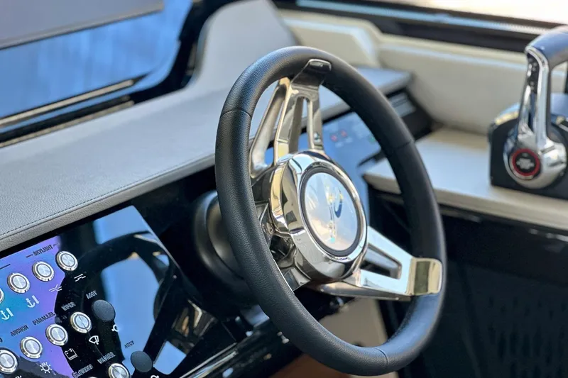 Slide: The Image of Steering wheel and controls of 2025 Sea Ray Sundancer 370 yacht cockpit. - 20