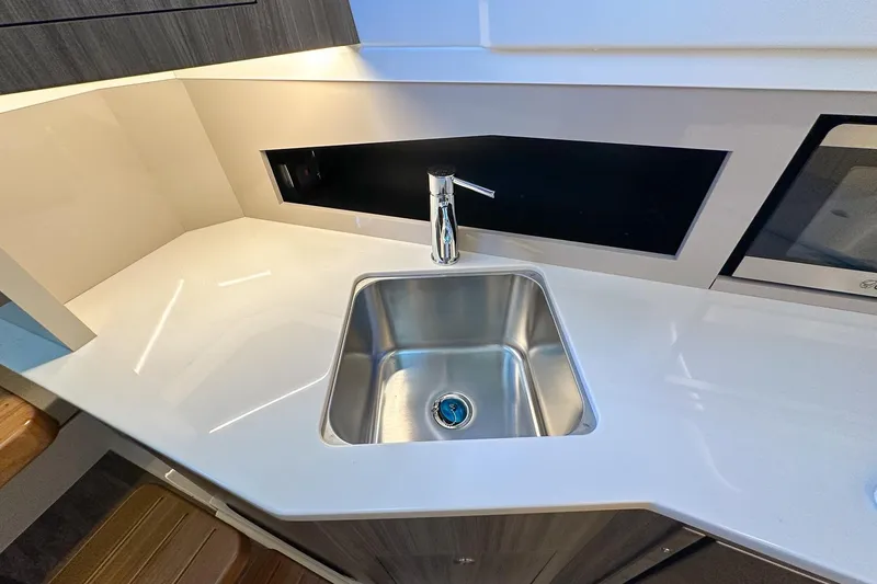 Slide: The Image of Modern kitchen sink area in 2025 Sea Ray Sundancer 370 yacht. - 28