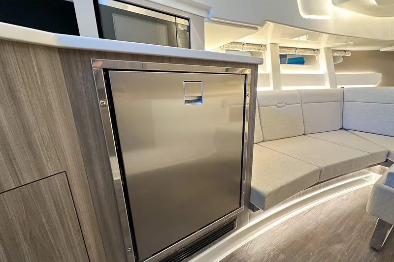 Slide: The Image of 2025 Sea Ray Sundancer 370 interior with modern kitchenette and cozy seating area. - 29