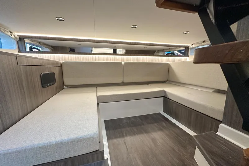 Slide: The Image of 2025 Sea Ray Sundancer 370 interior with modern seating and sleek design. - 40