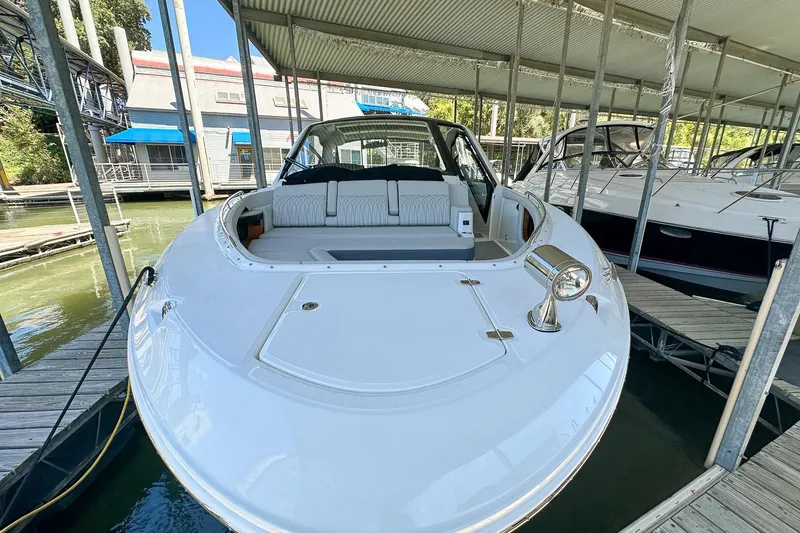 Slide: The Image of 2025 Sea Ray Sundancer 370 docked in a marina, showcasing sleek design and spacious seating. - 48