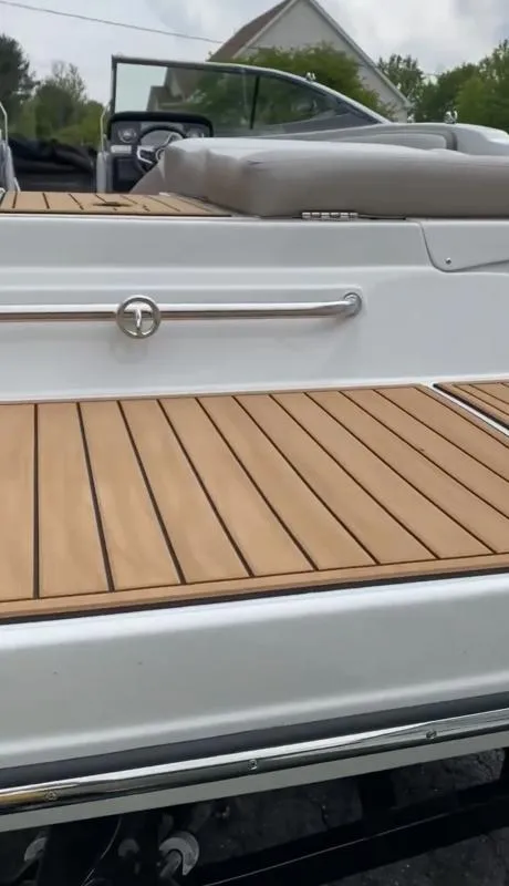 Slide: The Image of 2023 Crownline 240 SS boat with sleek teak deck and modern design. - 14