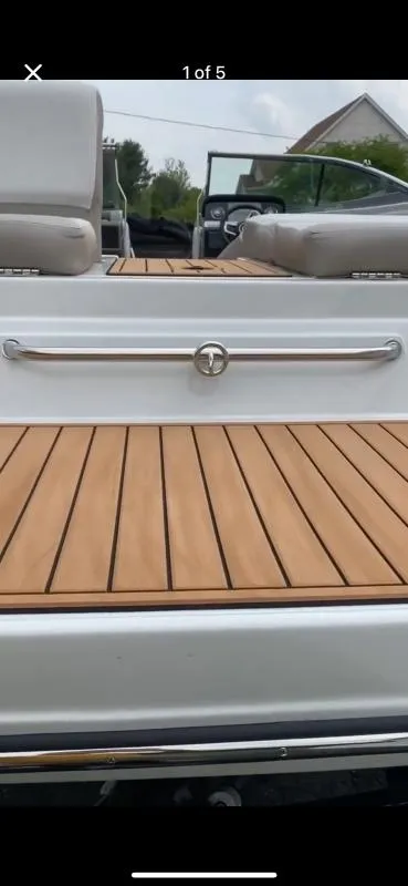 Slide: The Image of 2023 Crownline 240 SS boat with sleek deck and modern seating. - 5