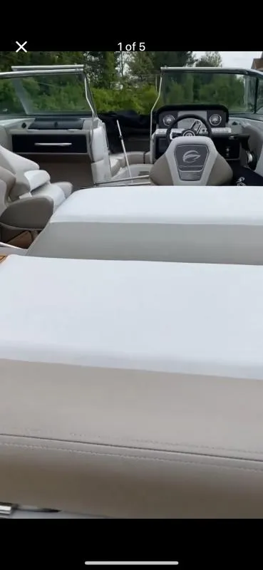 Slide: The Image of 2023 Crownline 240 SS boat interior with beige seating and modern dashboard. - 7