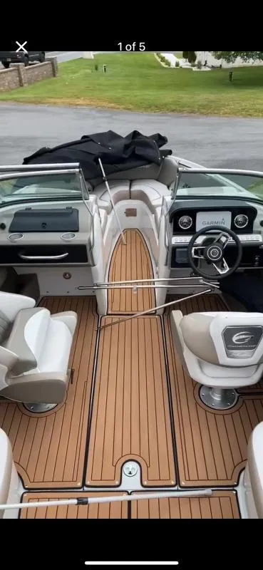 Slide: The Image of 2023 Crownline 240 SS boat interior with wood flooring and modern dashboard. - 9