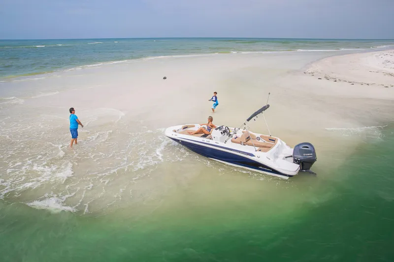 Slide: The Image of 2025 Hurricane SunDeck Sport 185 OB boat on sandy beach with people enjoying the water. - 13