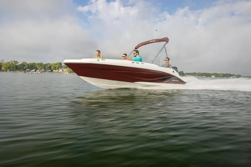 Slide: The Image of 2025 Hurricane SunDeck Sport 185 OB speeding on a lake with passengers. - 17