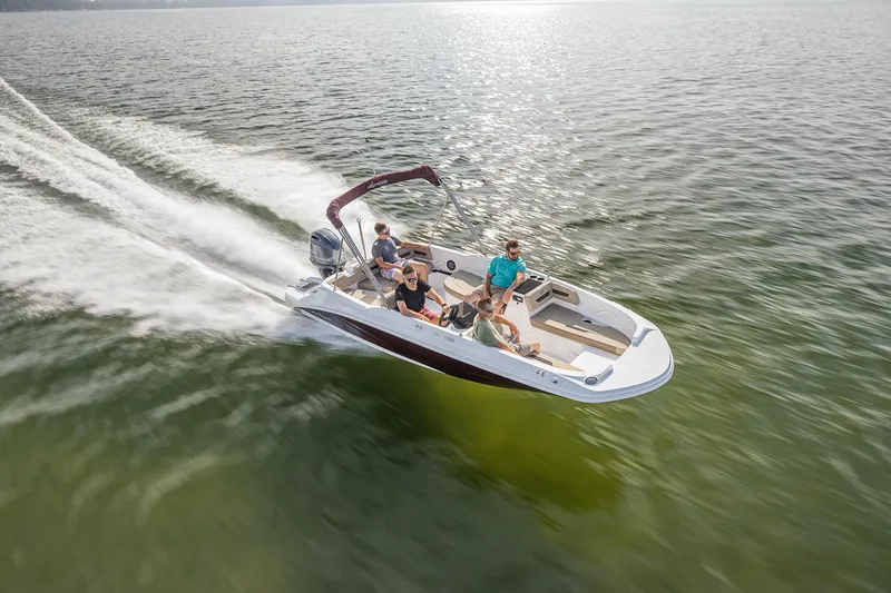 Slide: The Image of 2025 Hurricane SunDeck Sport 185 OB boat cruising on open water with passengers. - 20