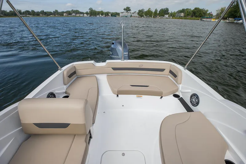 Slide: The Image of 2025 Hurricane SunDeck Sport 185 OB boat interior with beige seating on a lake. - 23