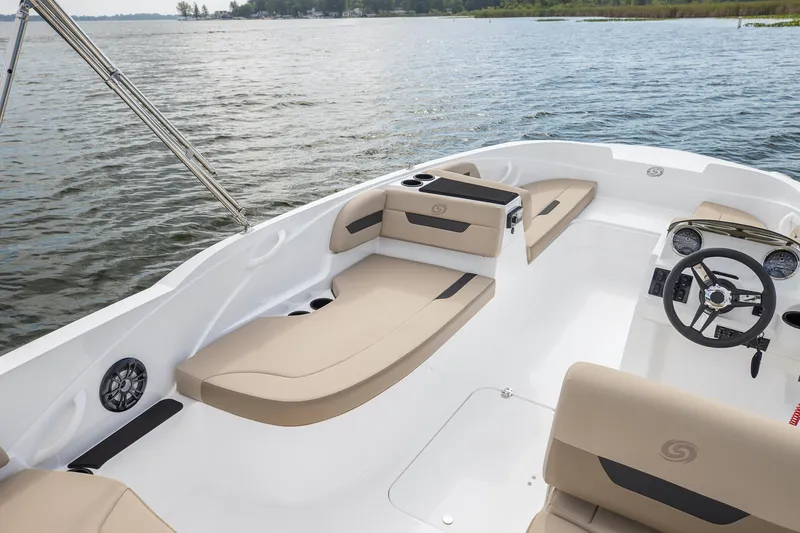 Slide: The Image of 2025 Hurricane SunDeck Sport 185 OB boat interior with beige seating on a calm lake. - 25