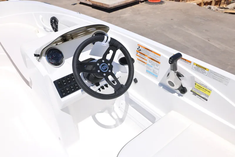 Slide: The Image of 2025 Hurricane SunDeck Sport 185 OB boat dashboard with steering wheel and control panel. - 5