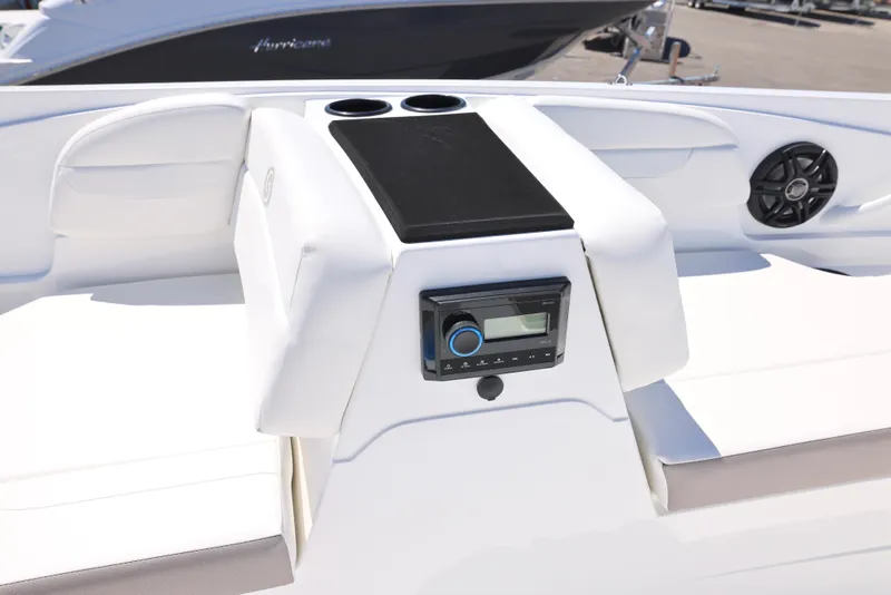 Slide: The Image of 2025 Hurricane SunDeck Sport 185 OB boat interior with stereo system and cup holders. - 9