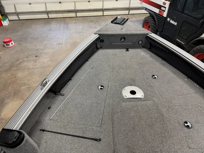 Slide: The Image of 2016 Lund 1875 Pro Guide boat interior, showing spacious deck and storage compartments. - 6