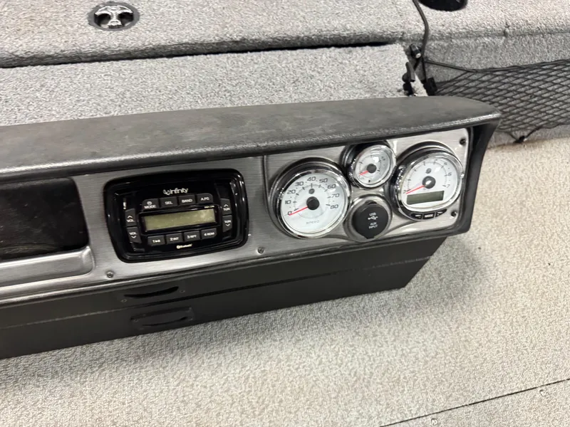 Slide: The Image of Dashboard of a 2016 Lund 1875 Pro Guide boat with gauges and radio. - 9