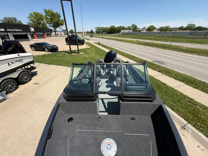 Slide: The Image of 2025 Lund 1650 Rebel XL Sport boat parked near a road, showcasing its sleek design. - 6
