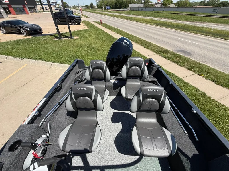 Slide: The Image of 2025 Lund 1650 Rebel XL Sport boat with four seats and outboard motor. - 8